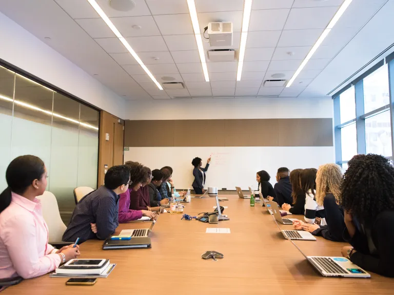 A group looking to the leader of a discussion.