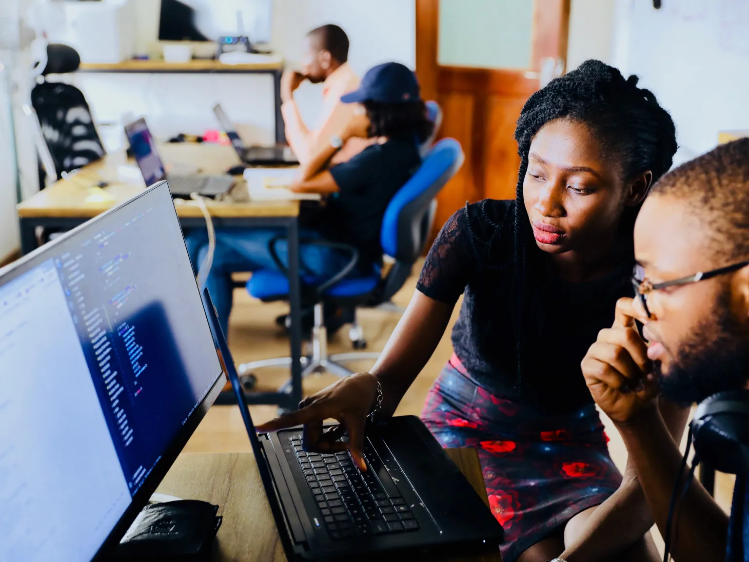 Two people looking at a computer