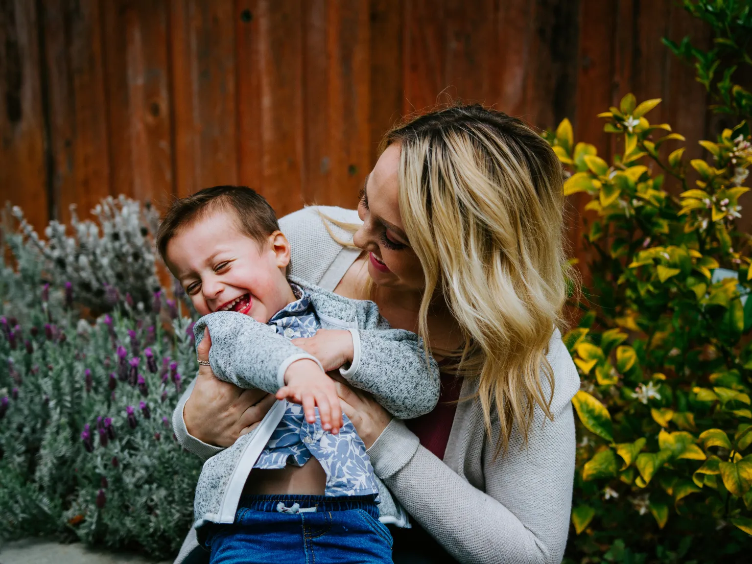 A mom hugging her son