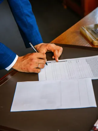 A professional signing paperwork